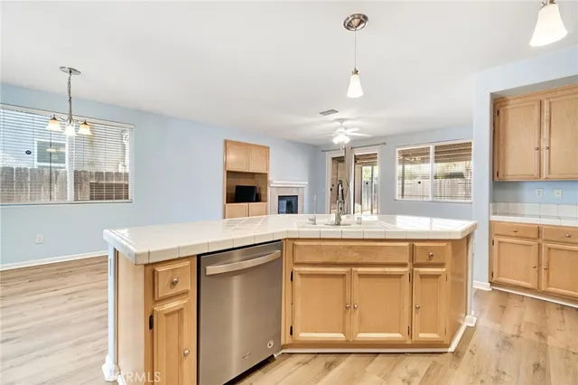 a kitchen with a stove and a sink with cabinets