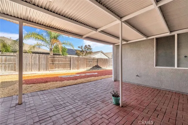 a view of house with backyard and ceiling fan