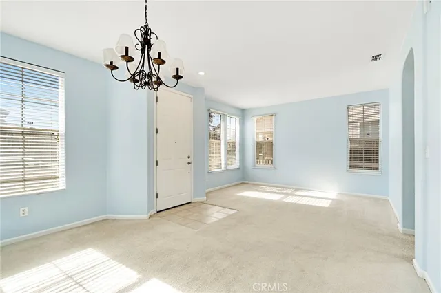a view of a livingroom with a chandelier furniture and windows