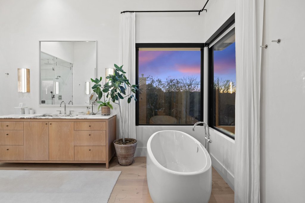 5 Inwood Cove Austin, TX 78746 - Photo 16 of 39 Full bathroom with vanity, light wood finished floors, and a soaking tub