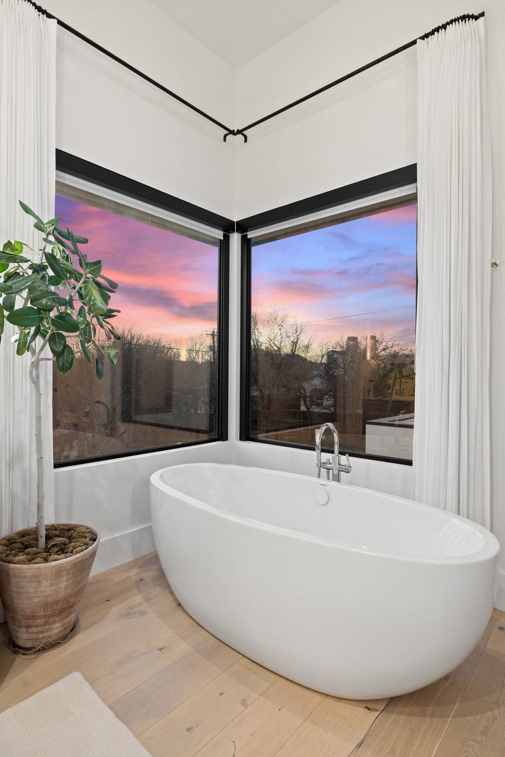 5 Inwood Cove Austin, TX 78746 - Photo 17 of 39 Bathroom with light wood-style flooring and a freestanding tub