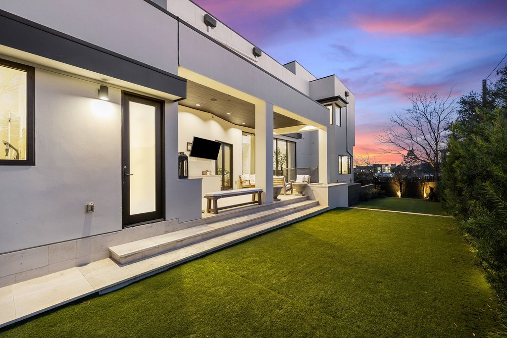 5 Inwood Cove Austin, TX 78746 - Photo 33 of 39 Rear view of house featuring a lawn, stucco siding, and a patio area