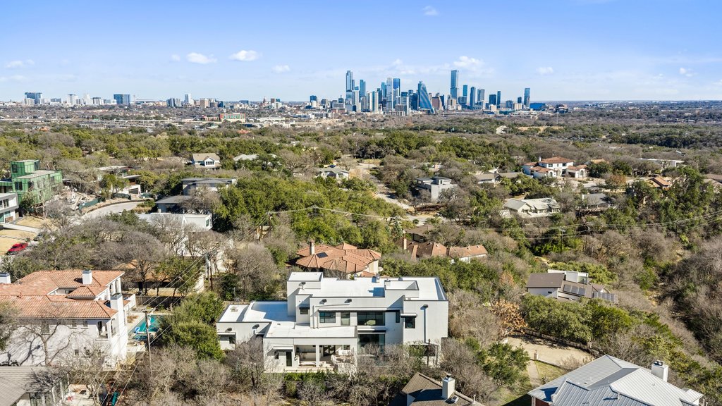 5 Inwood Cove Austin, TX 78746 - Photo 4 of 39 Aerial view of residential area featuring skyline and a tree filled landscape