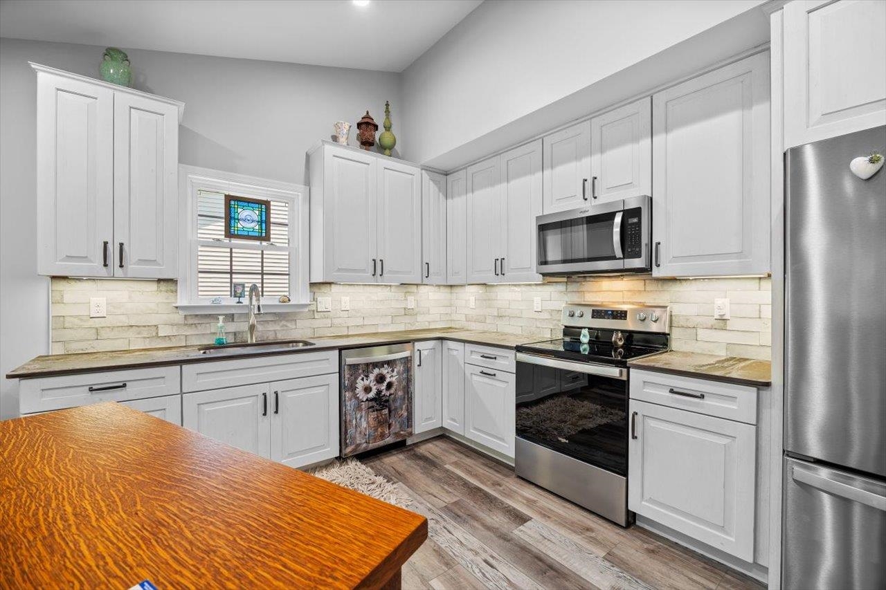 7 Oak View Drive Staunton, VA 24401 - Photo 7 of 53 a kitchen with stainless steel appliances granite countertop a stove top oven a sink dishwasher and a refrigerator with wooden floor