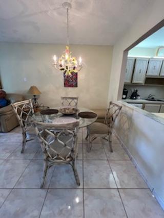 5681 Southwest 2nd Court, Unit 204 Margate, FL 33068 - Photo 13 of 22 a view of a dining room with furniture and a chandelier