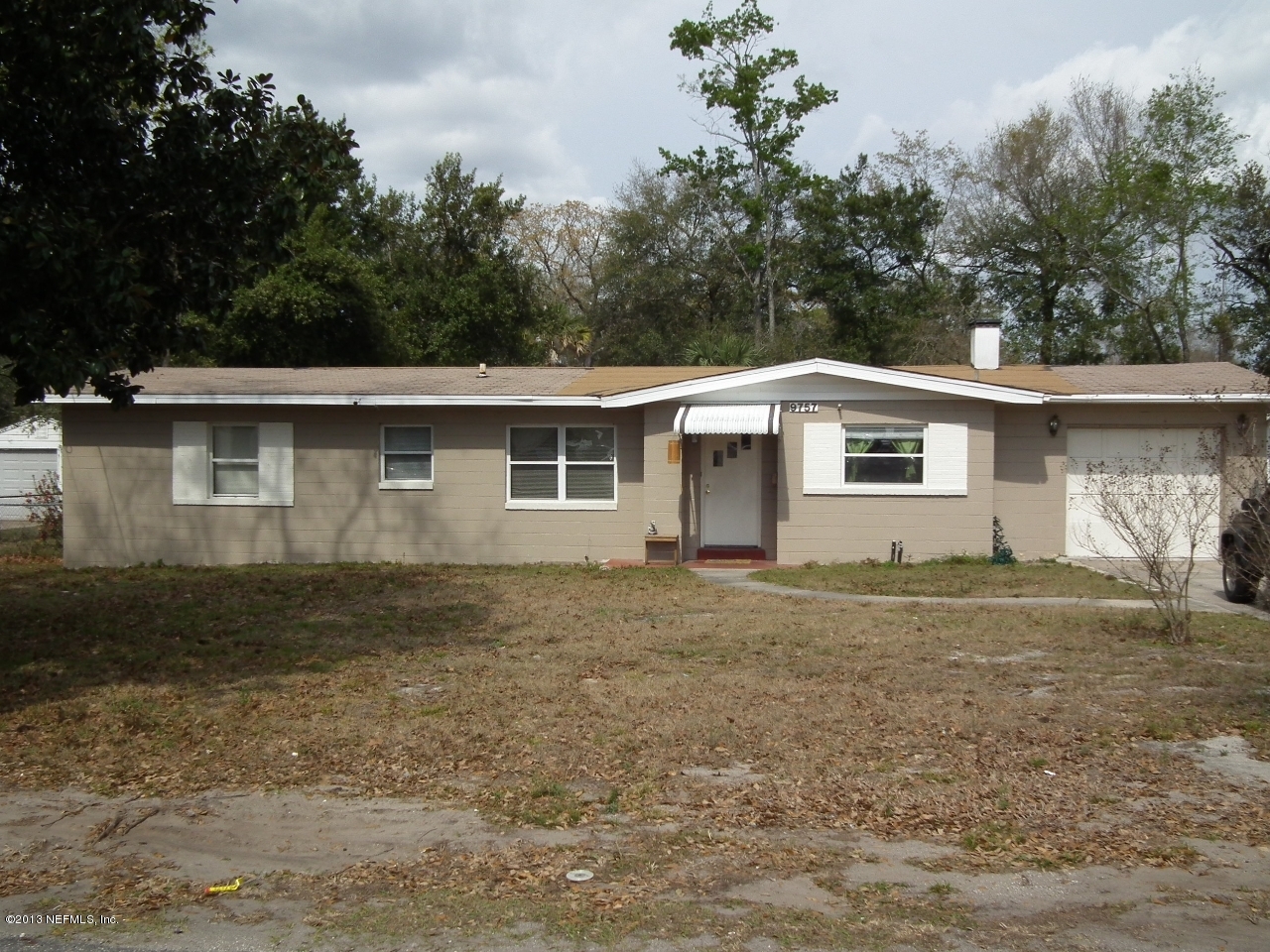9757 Patton Road Jacksonville, FL 32246 - Photo 1 of 6 a view of a house with a yard