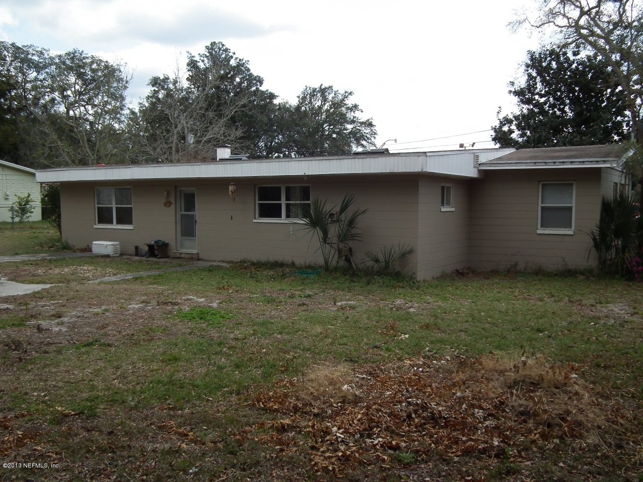 9757 Patton Road Jacksonville, FL 32246 - Photo 5 of 6 a house with trees in the background