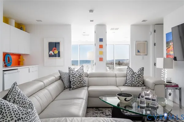 a living room with furniture and a floor to ceiling window