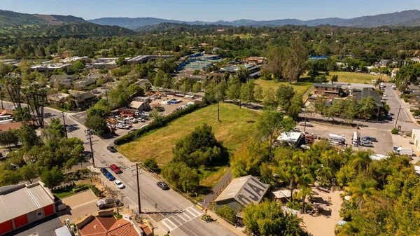 an aerial view of residential houses with outdoor space