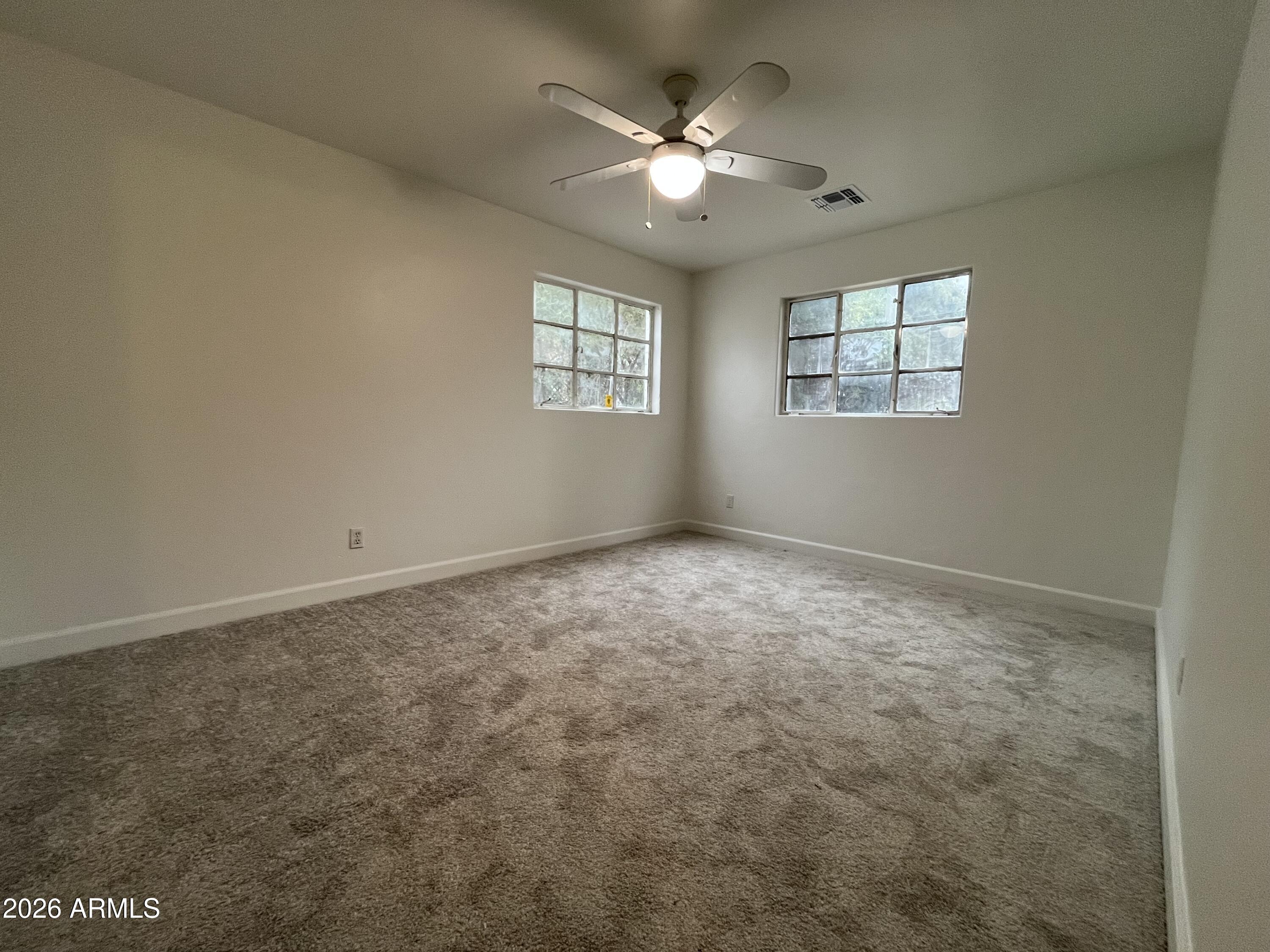 1226 South Roosevelt Street Tempe, AZ 85281 - Photo 12 of 26 an empty room with windows and ceiling fan