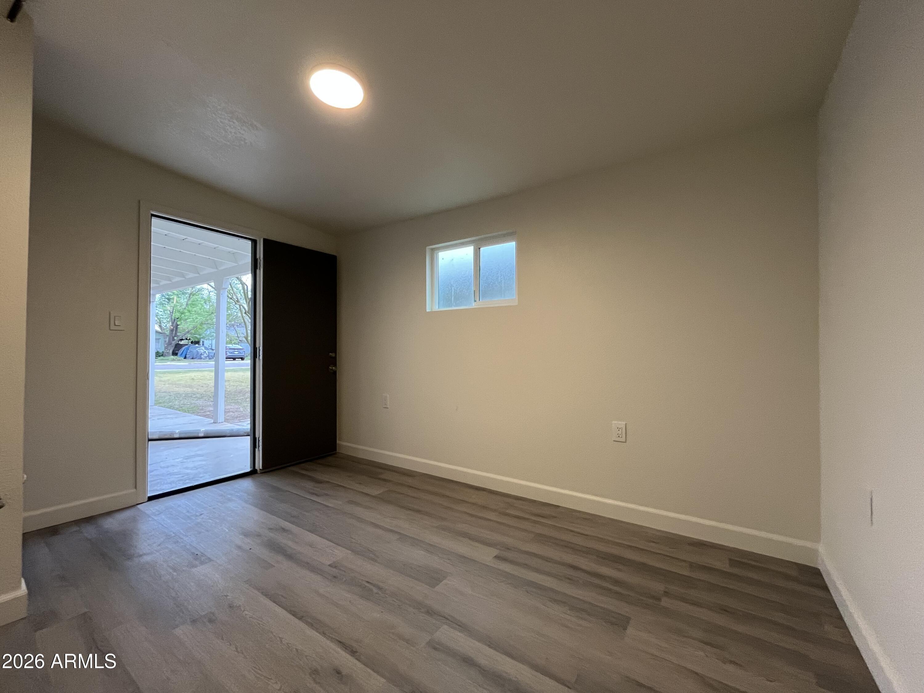 1226 South Roosevelt Street Tempe, AZ 85281 - Photo 15 of 26 an empty room with wooden floor and windows