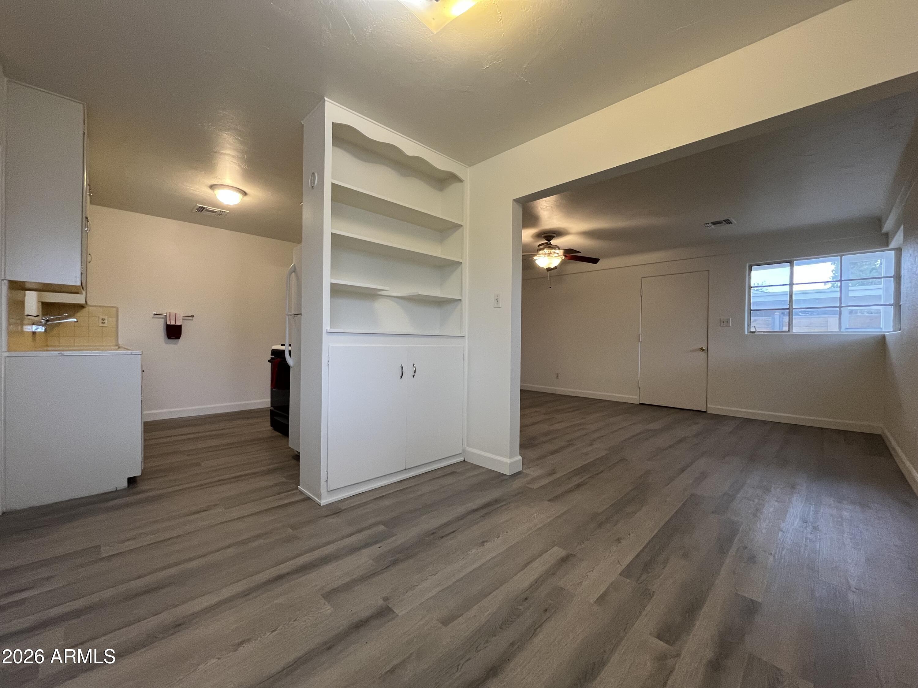 1226 South Roosevelt Street Tempe, AZ 85281 - Photo 6 of 26 a view of empty room with wooden floor and windows