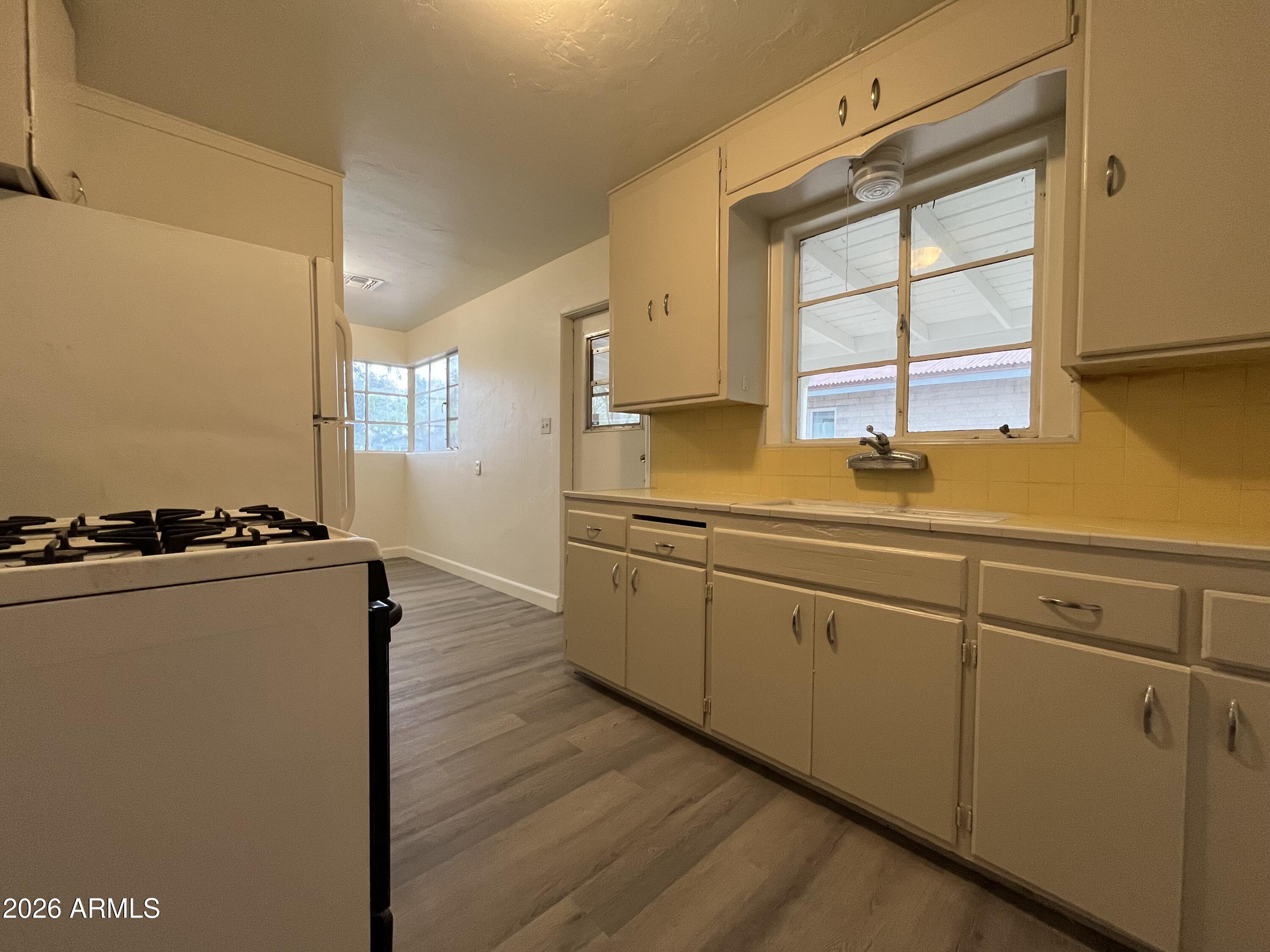 1226 South Roosevelt Street Tempe, AZ 85281 - Photo 8 of 26 a kitchen with sink cabinets and window