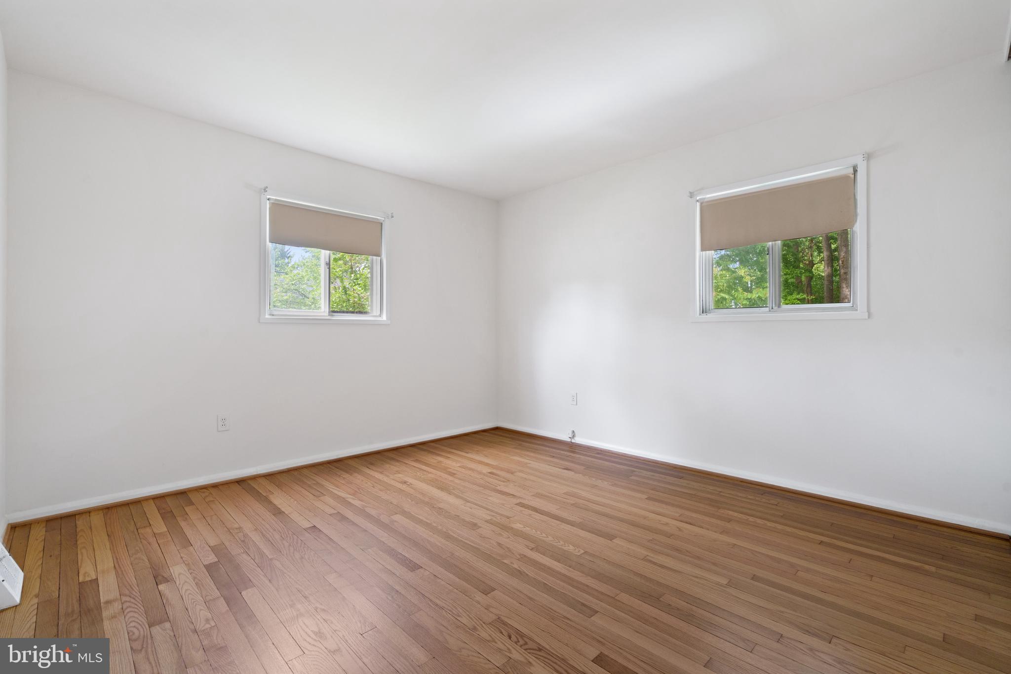 10204 Rodgers Road Fairfax, VA 22030 - Photo 11 of 29 a view of an empty room with wooden floor and a window