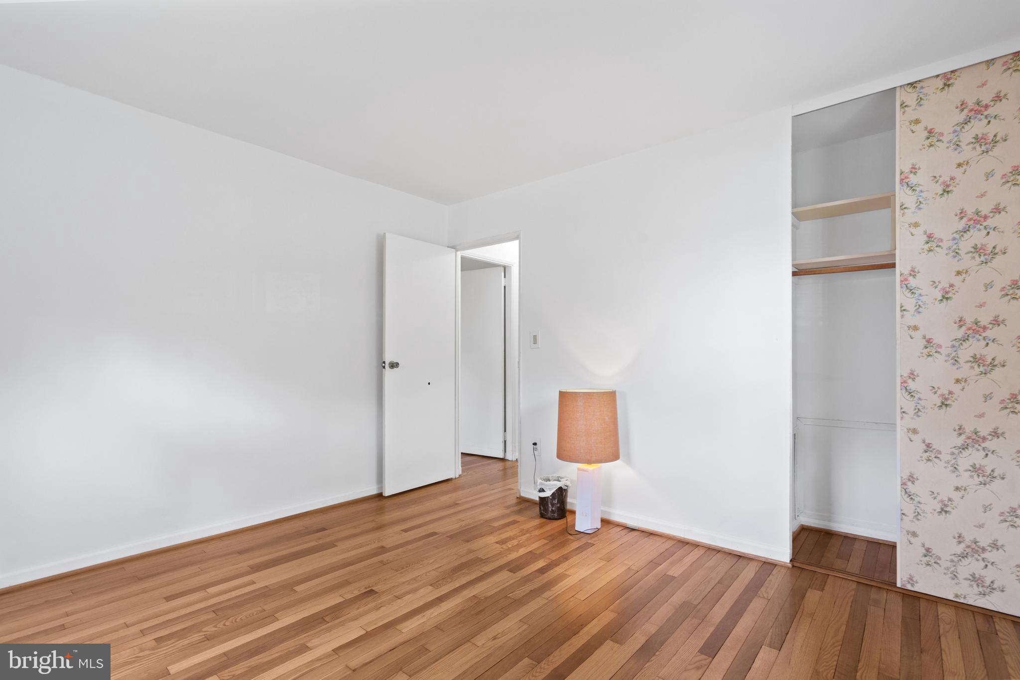 10204 Rodgers Road Fairfax, VA 22030 - Photo 14 of 29 a view of a room with wooden floor and a bench