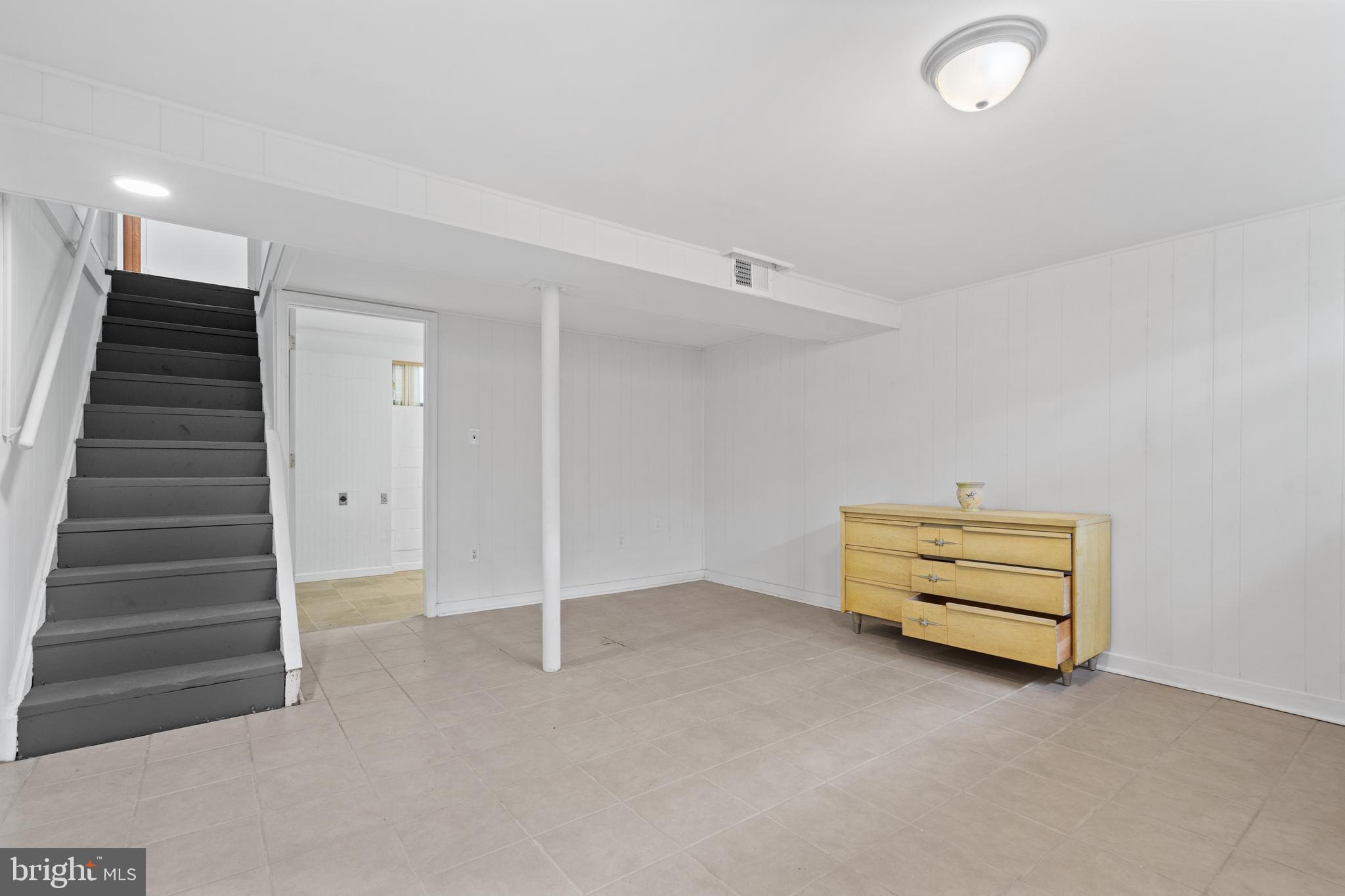 10204 Rodgers Road Fairfax, VA 22030 - Photo 18 of 29 an empty room with stairs and a ceiling fan