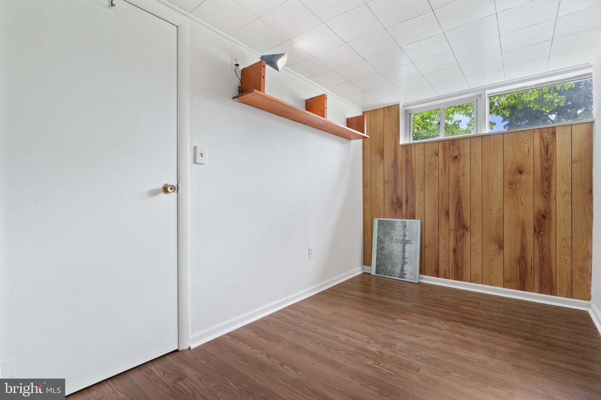 10204 Rodgers Road Fairfax, VA 22030 - Photo 21 of 29 an empty room with wooden floor and a window