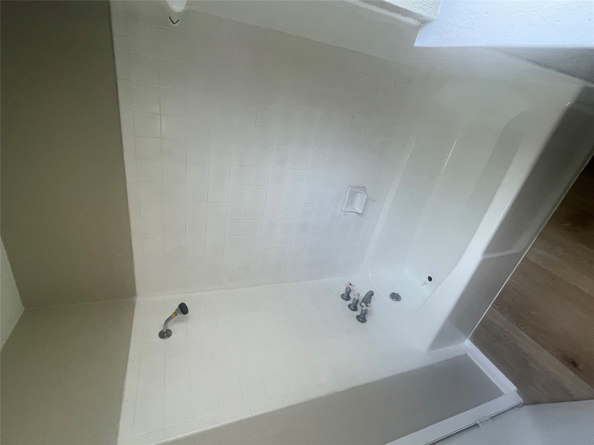 4620 Button Bend Road Austin, TX 78744 - Photo 12 of 22 A well-maintained bathroom featuring a classic tub and shower combination with sleek tile surround.