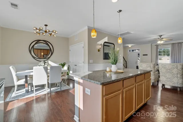 a kitchen with stainless steel appliances granite countertop a sink stove and cabinets