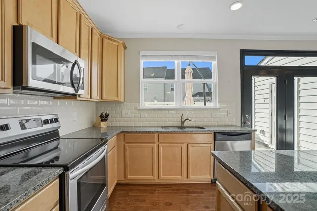 a view of a dining room with furniture and a chandelier
