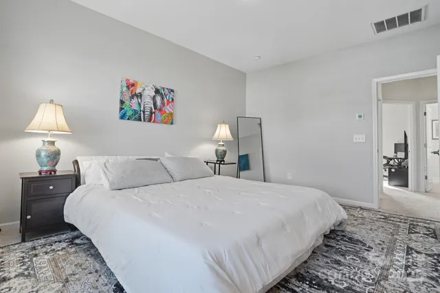 a bedroom with a bed and a mirror