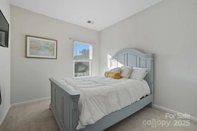 a bedroom with a bed and a lamp