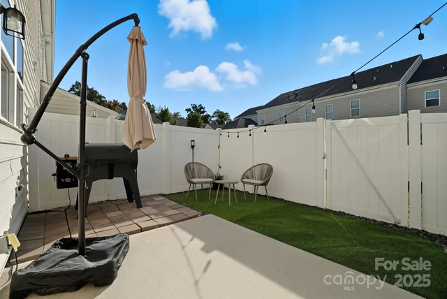 a backyard of a house with table and chairs