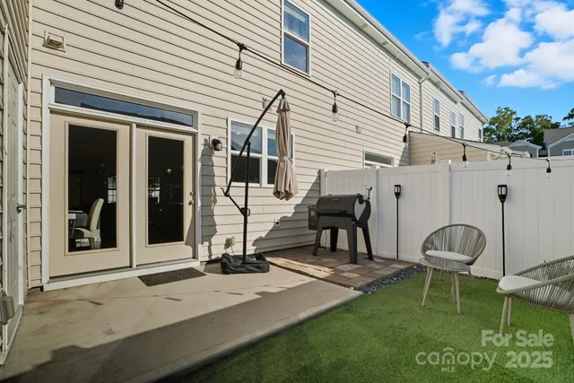 a view of a house with backyard and sitting area