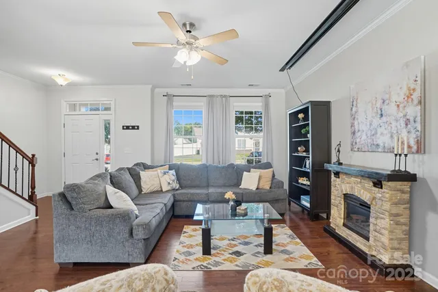 a living room with furniture a fireplace and a flat screen tv