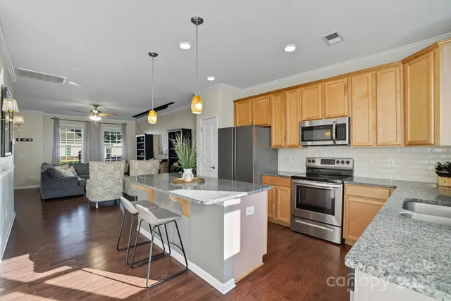 a kitchen with sink a microwave and refrigerator