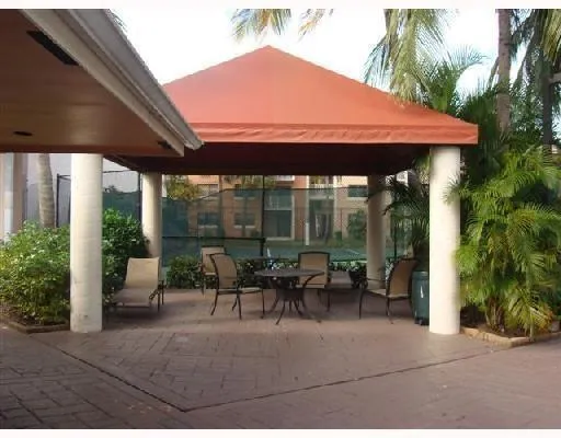 an outdoor sitting area with furniture and garden view