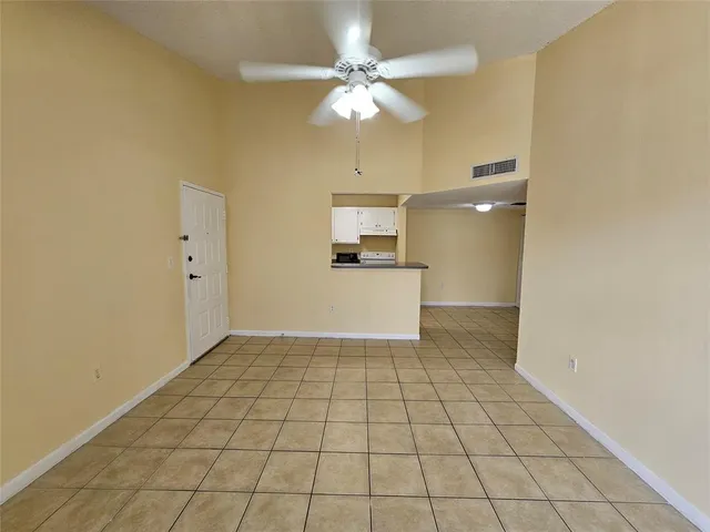 a view of a kitchen with a sink and a refrigerator