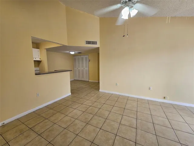 a view of a livingroom with an empty space and a window