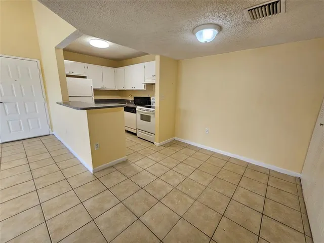 a kitchen with stainless steel appliances a refrigerator and a stove top oven