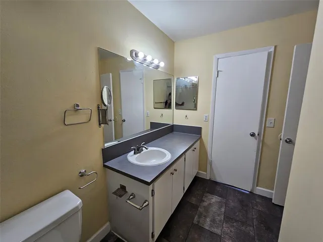 a bathroom with a sink a light fixture and a mirror
