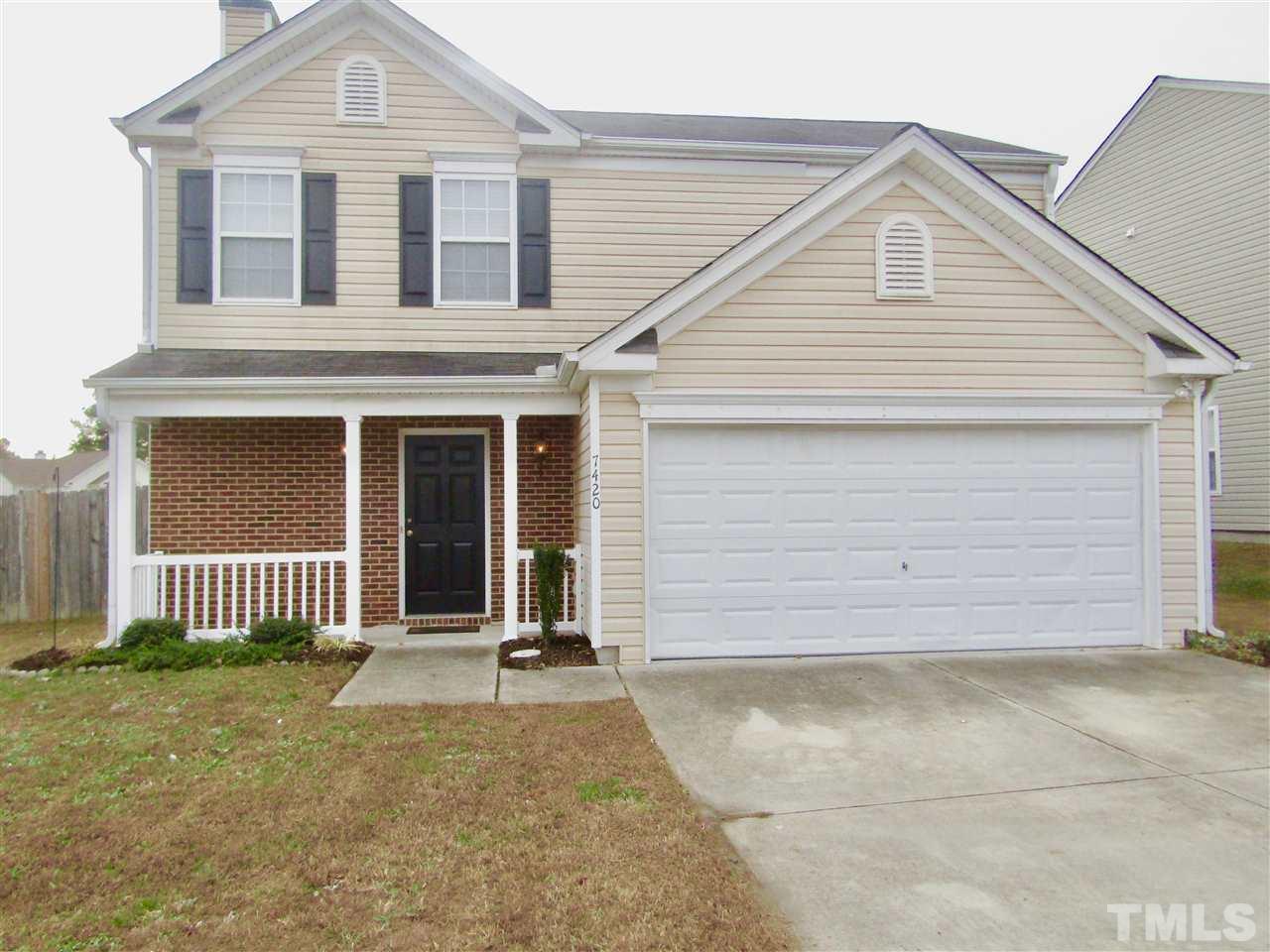 7420 Lowell Ridge Road Raleigh, NC 27616 - Photo 1 of 21 a front view of a house with a garage