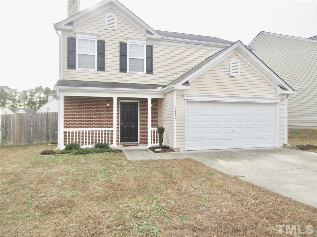 7420 Lowell Ridge Road Raleigh, NC 27616 - Photo 2 of 21 a front view of a house with a garage
