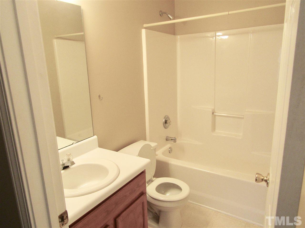 7420 Lowell Ridge Road Raleigh, NC 27616 - Photo 11 of 21 a bathroom with a sink a toilet and shower