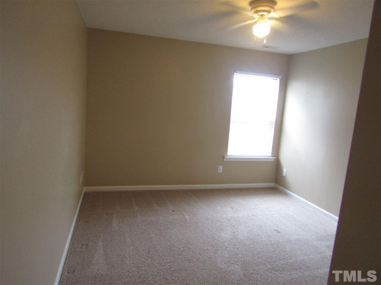 7420 Lowell Ridge Road Raleigh, NC 27616 - Photo 12 of 21 en empty room with windows and chandelier fan