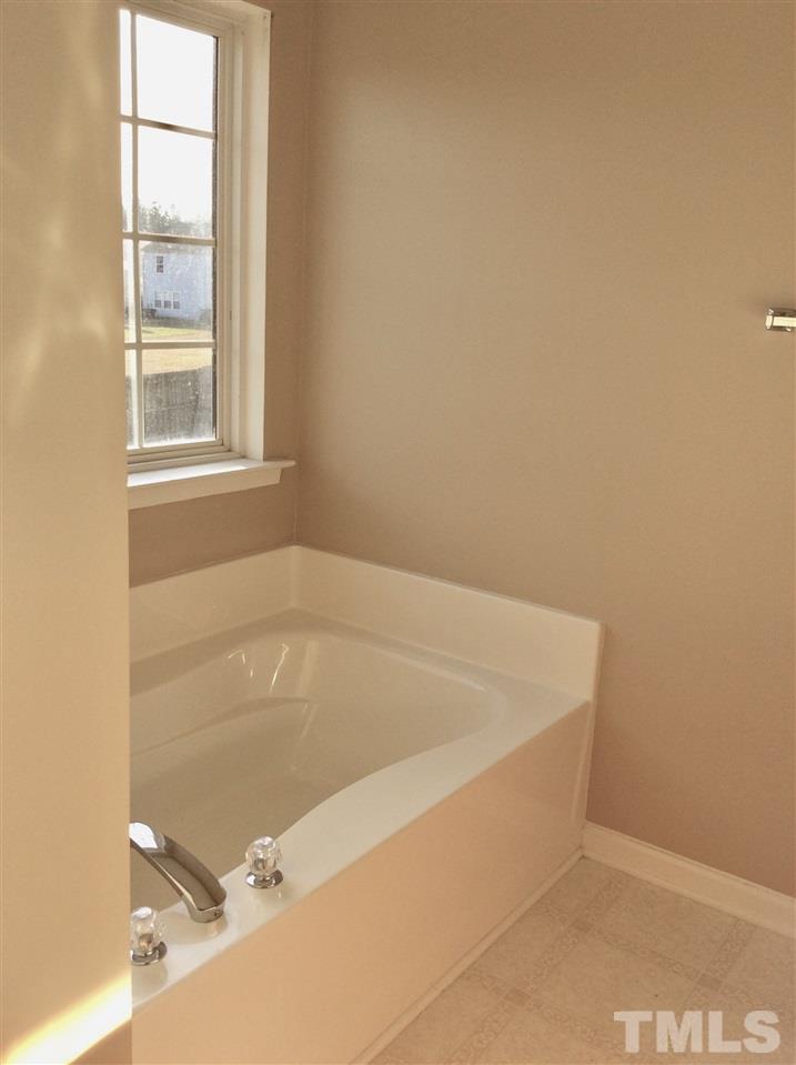 7420 Lowell Ridge Road Raleigh, NC 27616 - Photo 18 of 21 a bath tub sitting in a bathroom next to a window