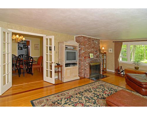 10 Stage Coach Road Boxford, MA 01921 - Photo 8 of 21 a living room with furniture flat screen tv and a fireplace