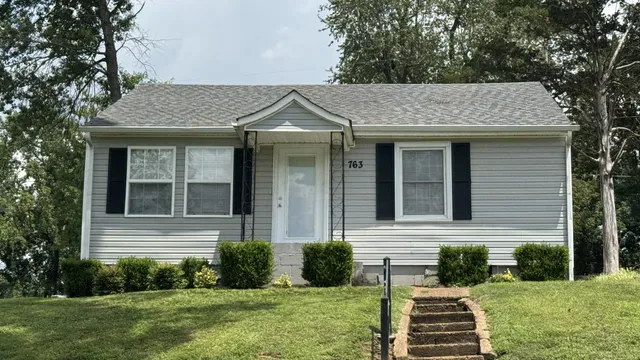 front view of a house with a yard