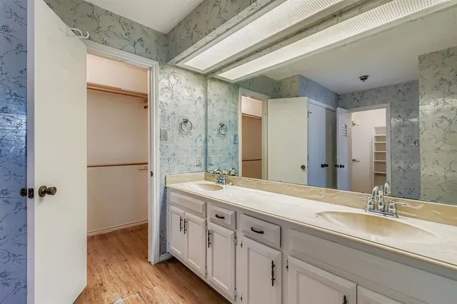 a spacious bathroom with a double vanity sink mirror and double