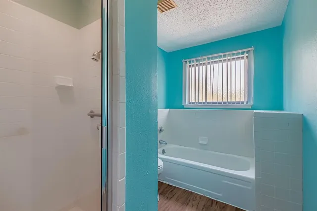 a view of bathroom with bathtub and shower