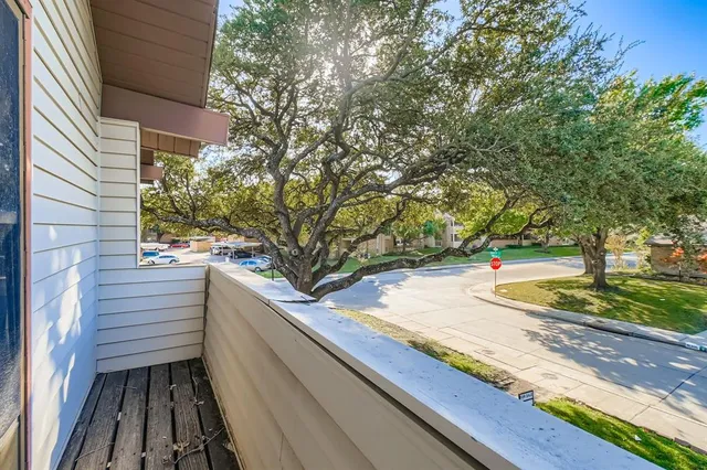 a view of a balcony with yard