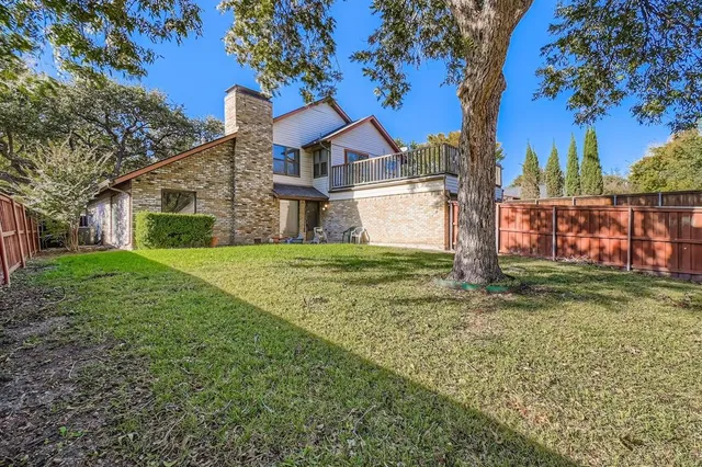 a house that has a tree in front of it