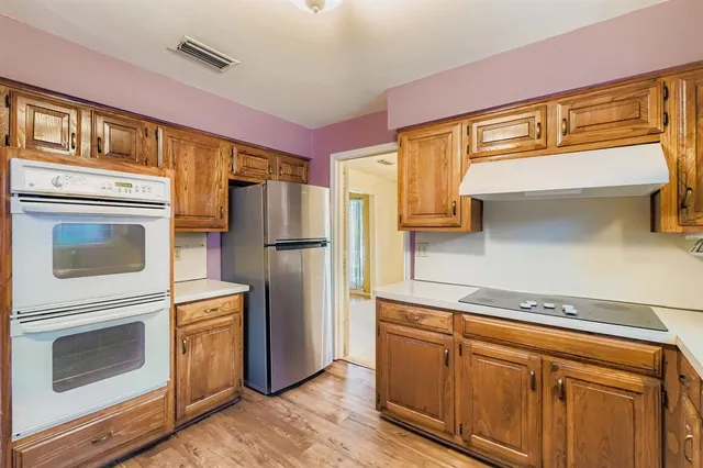 a kitchen with appliances cabinets and a counter top space