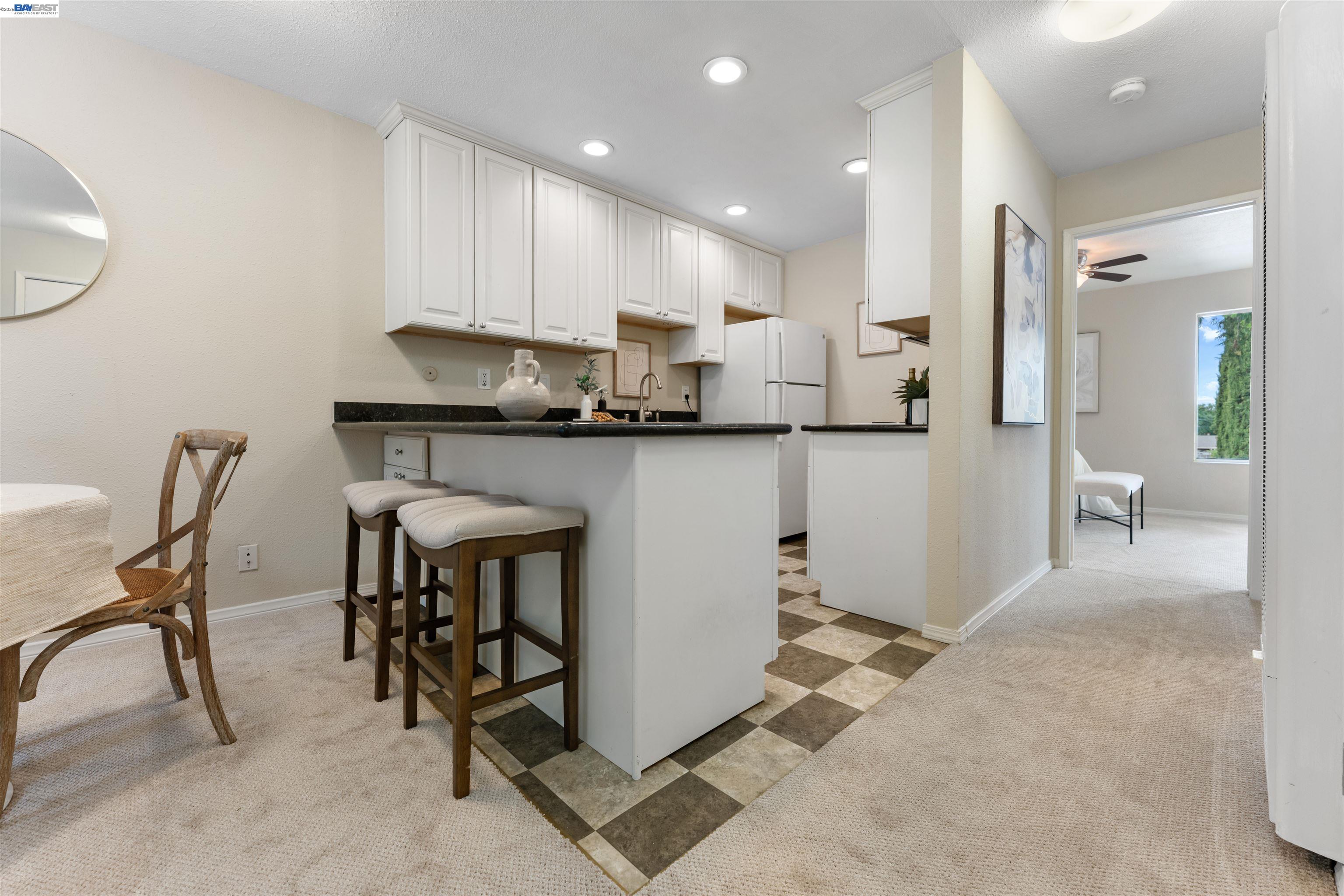 4081 Clayton Road, Unit 221 Concord, CA 94521 - Photo 8 of 23 a kitchen with stainless steel appliances granite countertop table chairs sink and cabinets