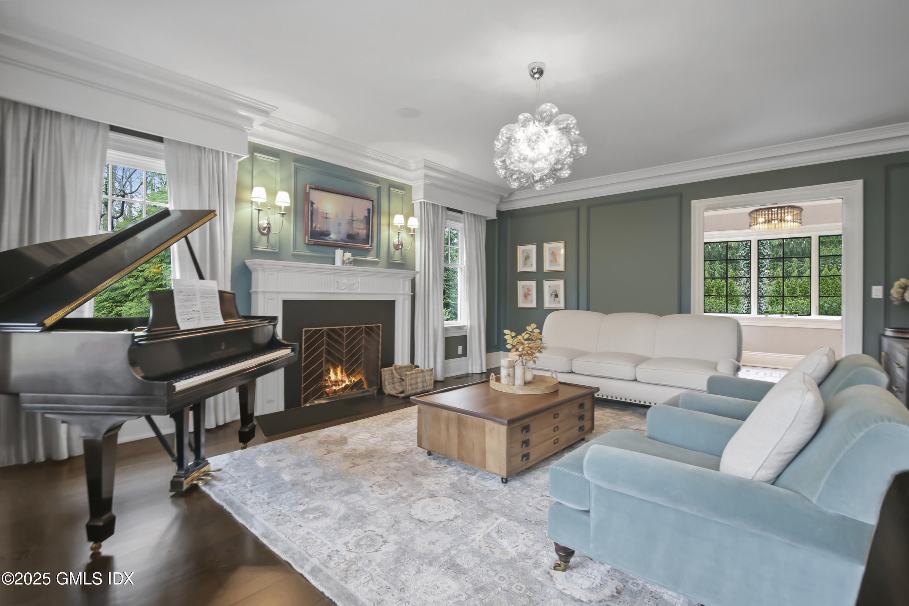 45 Willow Road Riverside, CT 06878 - Photo 4 of 14 a living room with furniture a chandelier and a fireplace