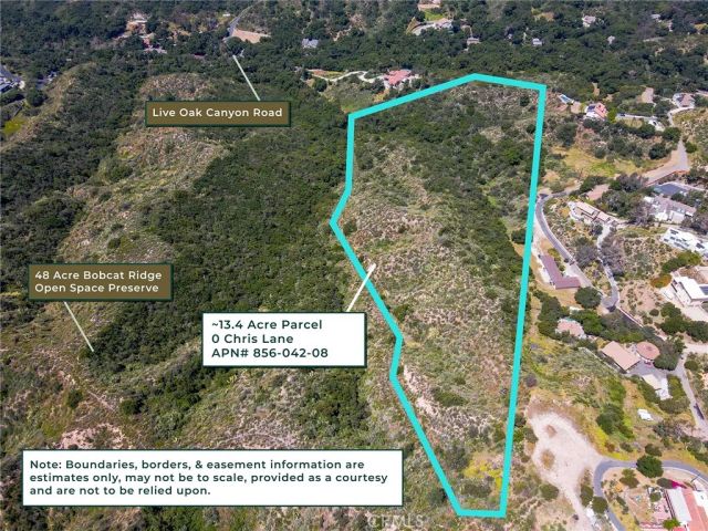 a view of a lush green field with mountains in the background